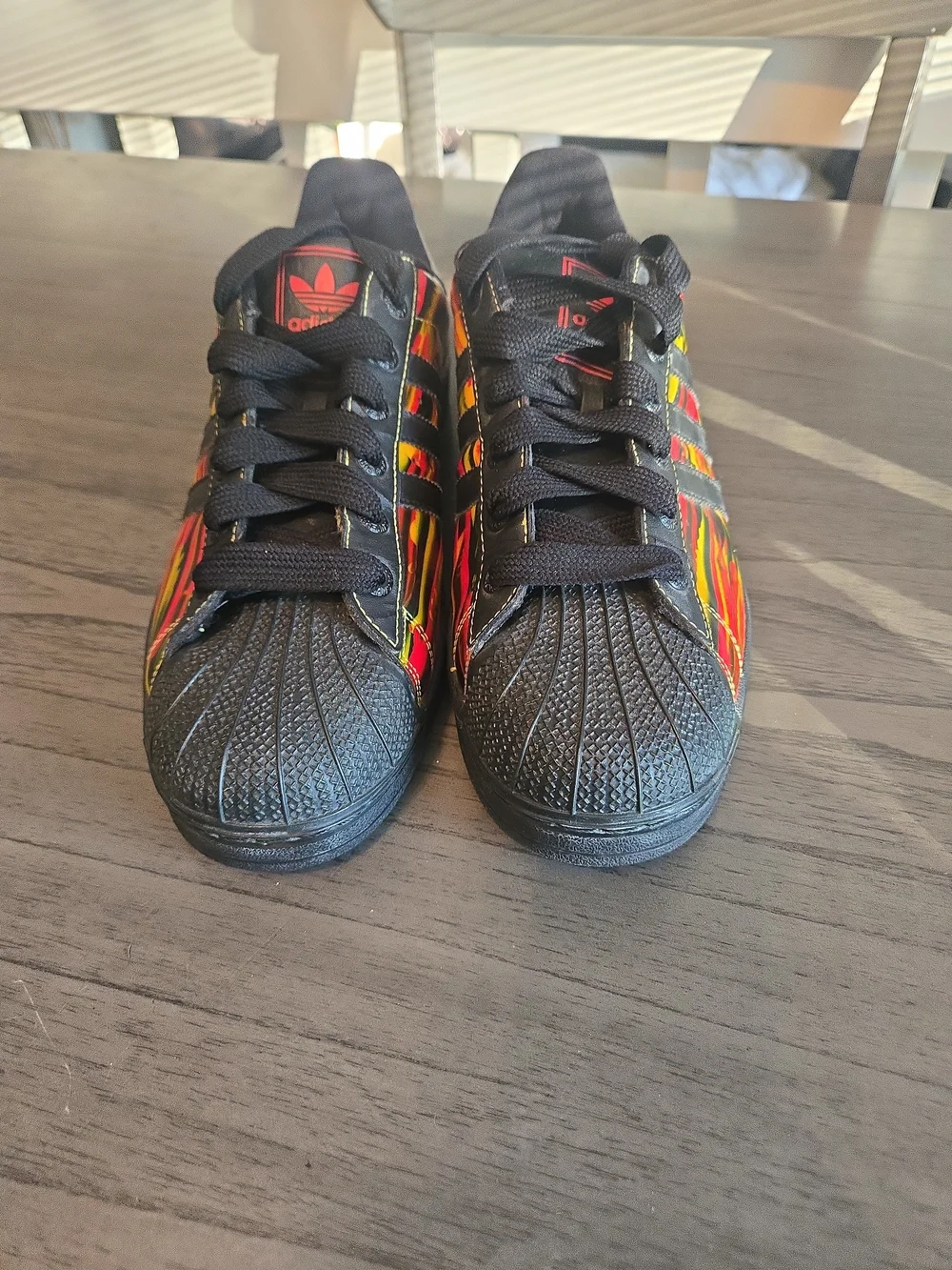 Adidas Black Superstar Sneakers with Red & Yellow Graphic